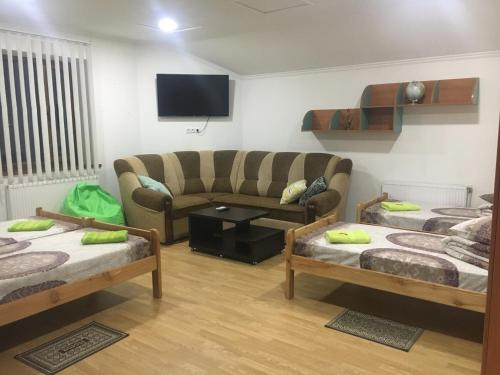 a living room with three beds and a couch at AlekSelena in Malekhuv