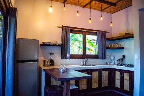 a kitchen with a sink and a window at Lua Villas in Santa Teresa Beach