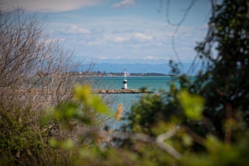 a lighthouse on a small island in the water at Koronisia Apartments in Koronisia