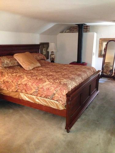 a bedroom with a large bed with a fireplace at General Warren in Malvern