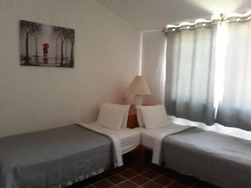 Postel nebo postele na pokoji v ubytování Hotel La Rinconada Tequisquiapan