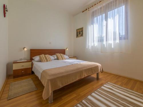 a bedroom with a large bed and a window at Apartment Nevelina in Selce
