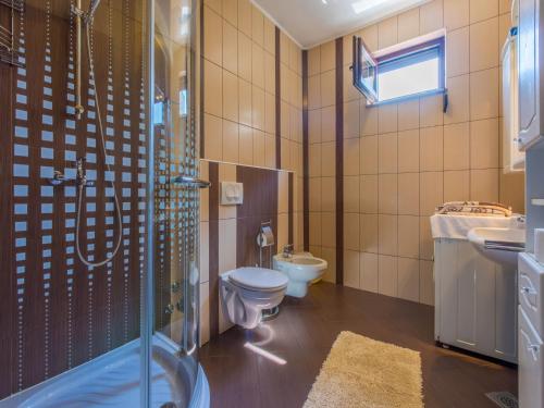 a bathroom with a toilet and a sink and a shower at Apartment Nevelina in Selce