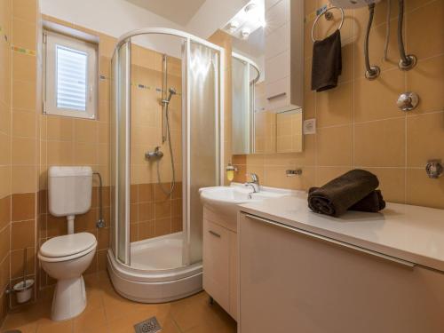 a bathroom with a shower and a toilet and a sink at Apartment Color Green in Dramalj