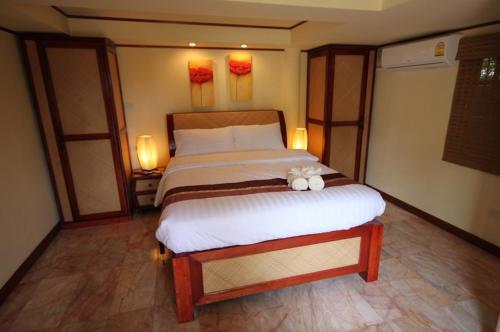 a bedroom with a bed with a teddy bear on it at 7 Bedroom Seafront Villa Phangan SDV232-By Samui Dream Villas in Srithanu