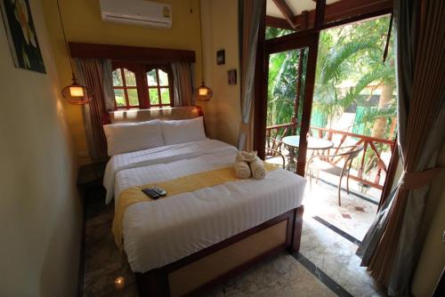 a bedroom with two beds and a large window at 7 Bedroom Seafront Villa Phangan SDV232-By Samui Dream Villas in Srithanu