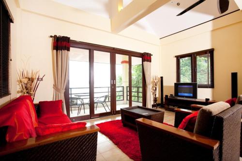 a living room with a couch and a television at 3 Bedroom Seaview Island View Koh Phangan SDV233-By Samui Dream Villas in Srithanu