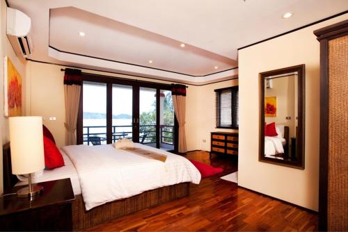 a bedroom with a bed and a large mirror at 3 Bedroom Seaview Island View Koh Phangan SDV233-By Samui Dream Villas in Srithanu