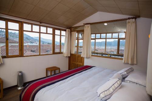 a hotel room with a bed and a window at MOAF Cusco Boutique Hotel in Cusco