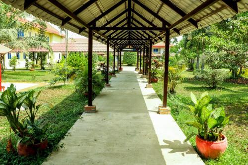 a walkway in a garden with potted plants at Don Bosco Hotel School in Sihanoukville