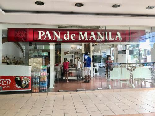 a store front of a mall with a sign that reads pan de manilla at The Persimmon Studios Near Ayala and SM City Cebu in Cebu City