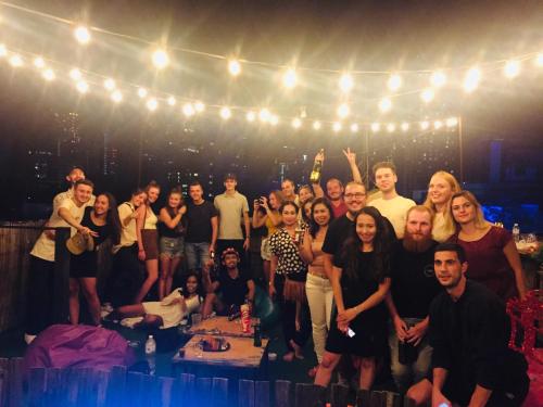 a group of people posing for a picture on a stage at Revolution Asoke in Bangkok