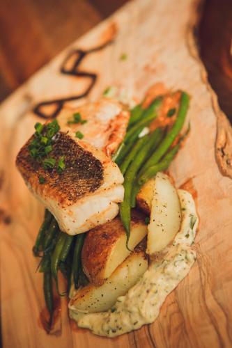 a plate of food with meat and vegetables on a cutting board at DoubleTree by Hilton Ottawa Downtown in Ottawa