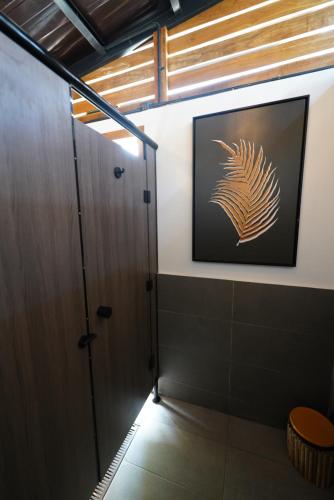 a bathroom with a door and a picture on the wall at Nacpan Beach Glamping Managed by H Hospitality Group in El Nido