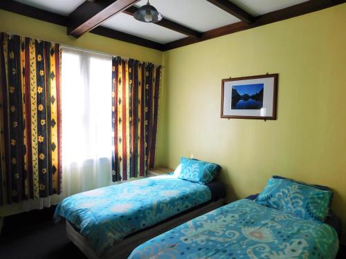 a bedroom with two beds and a window at Rotorua Central Backpackers in Rotorua