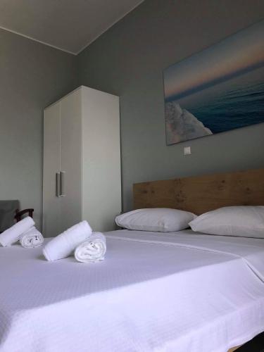a bedroom with a bed with white sheets and pillows at Light blue studios 2 in Poúlithra