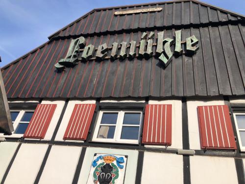a black and white building with a sign on it at Hotel & Gastropark Loemühle in Marl