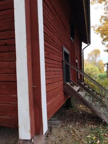 a red building with a staircase on the side of it at Risberg Herrgård in Hagfors