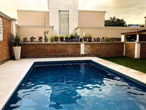 a swimming pool in the backyard of a house at Hotel Bugambilias Rooms in Tequisquiapan