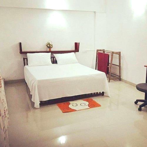 a bedroom with a bed and a rug on the floor at Mountview Homestay Kandy in Kandy