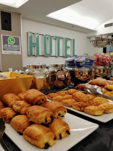 a buffet of pastries and other pastries on a table at Hotel Piccolo in Verona