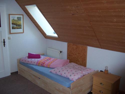 a bedroom with a bed and a skylight at Ferienwohnung "An der St. Ludmila" in Crostwitz