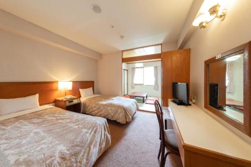 Postel nebo postele na pokoji v ubytování Akakura Hotel