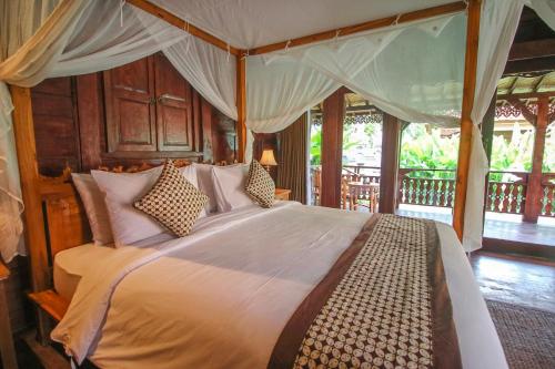 Postel nebo postele na pokoji v ubytování Ari Cottages Ubud