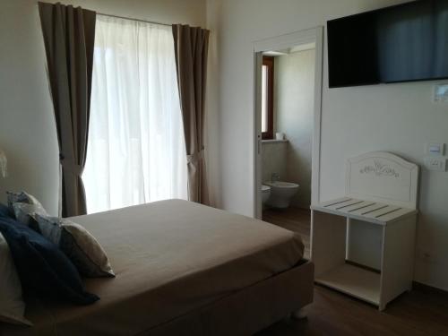a bedroom with a bed and a large window at B&B CasalFarano in Cupra Marittima