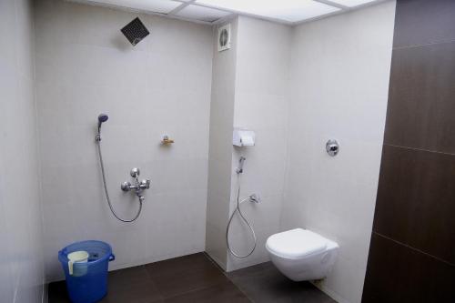 a bathroom with a shower with a toilet and a shower at Venkat Presidency in Navi Mumbai