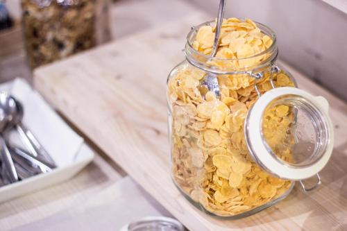 a glass jar filled with peanuts on a counter at Best Western Modena District in Campogalliano
