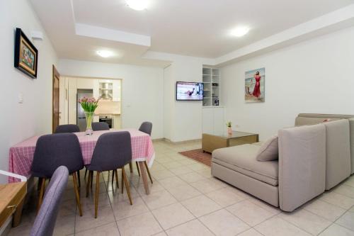 a living room with a table and a couch at Apartments Leon in Podstrana
