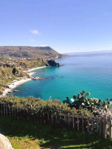 a view of a beach with blue water at Villa Grazia in Capo Vaticano
