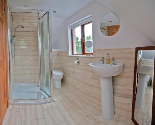 a bathroom with a shower and a sink and a toilet at Lugonia in Pitlochry