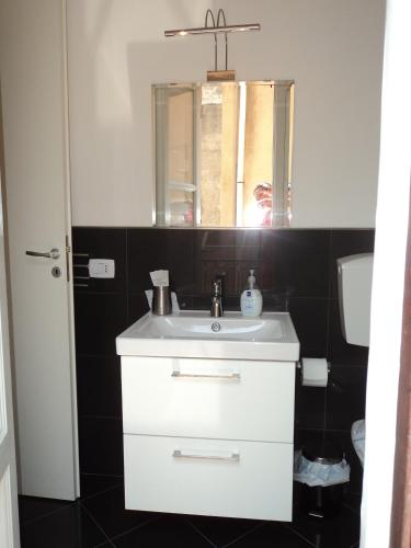 a bathroom with a white sink and a mirror at Anita & Garibaldi in Marsala