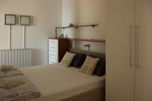 a bedroom with a large white bed with two pillows at Studio apartman Dida Bozo in Senj