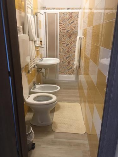 a bathroom with a toilet and a sink at Locanda Ponte Rosa in Garessio