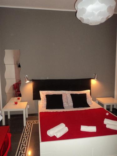 a bedroom with a red bed with two white pillows at Anita & Garibaldi in Marsala