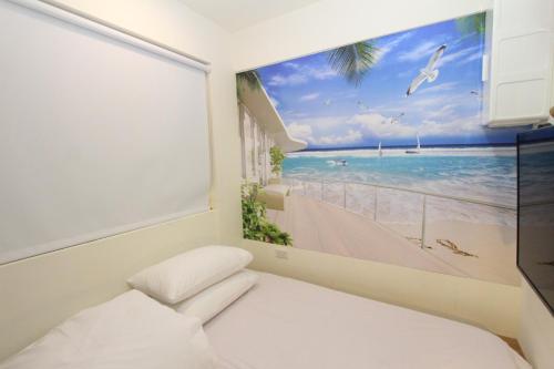 a bedroom with a large window with a picture of the beach at Sea Keelung in Keelung