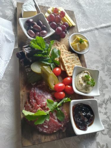 a plate of food with meat and vegetables on a table at Gerald's Gift Guest House in Addo