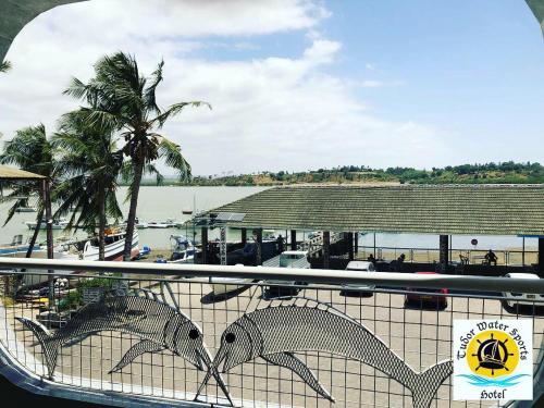 two fish statues on a fence next to a beach at Tudor Water Sports Hotel in Mombasa