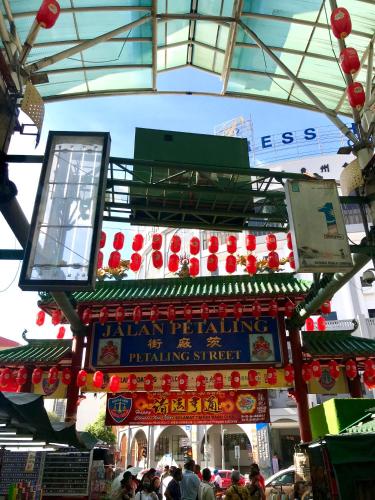 a sign for a market with people walking around at Lavana Hotel, Chinatown in Kuala Lumpur