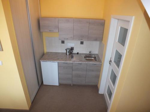 a small kitchen with a sink and a counter at Garden apartments in Znojmo