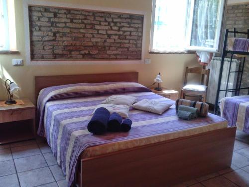 a bedroom with a bed with two pairs of shoes on it at Agriturismo Trava in Portoverrara