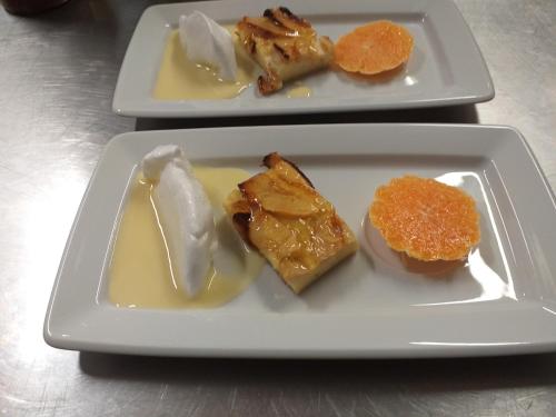 two white plates with different types of food on them at Logis Hôtel Restaurant de la Dore in Vertolaye