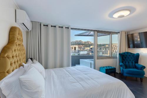 a bedroom with a white bed and a blue chair at Athenian Lofts in Athens