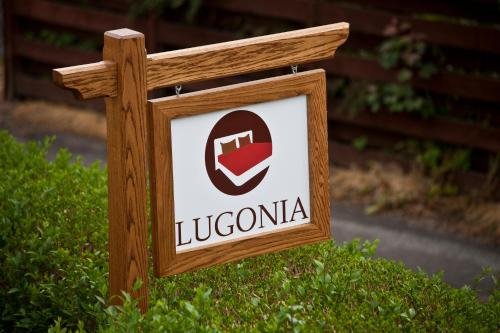 a wooden sign with a lucciania logo on it at Lugonia in Pitlochry