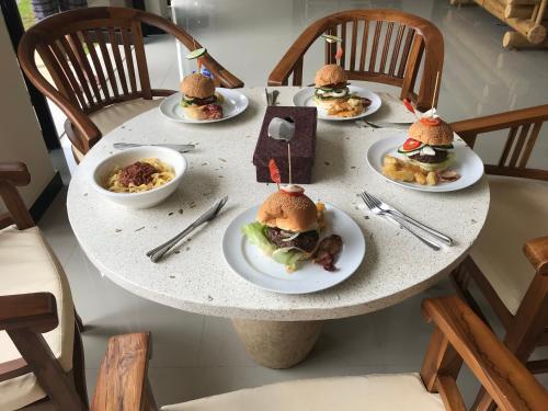 a table with plates of food on it at Villa Viking in Jimbaran