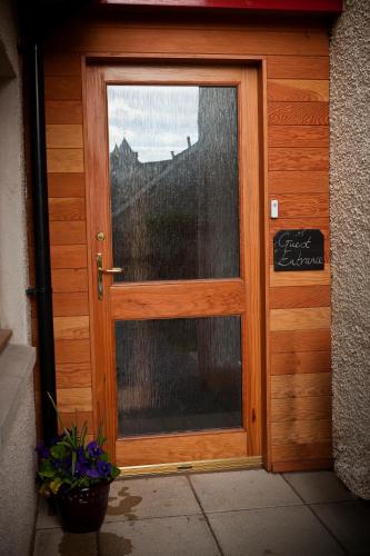 a wooden door with a sign in front of it at Lugonia in Pitlochry