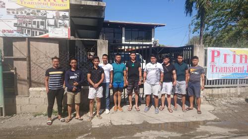 a group of men posing for a picture in front of a building at Prince Transient house in San Jose
